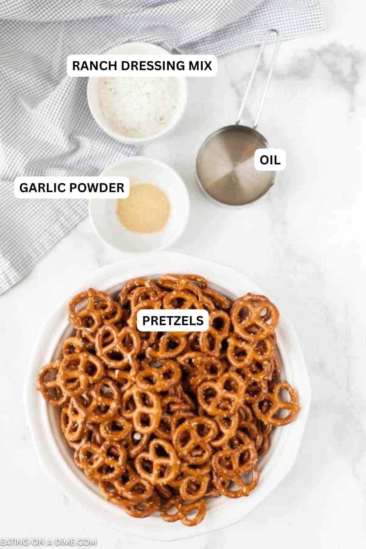 You'll love this Ranch Pretzel recipe. This quick recipe only requires 4 ingredients to make delicious snack mixes. You can also make spicy ranch pretzels in the oven with olive oils with this simple & easy recipe! #eatingonadime #snackrecipes #ranchpretzels Ingredients for recipe: ranch dressing mix, oil, garlic powder, pretzels.