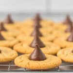 Gluten free peanut butter kiss cookies on a wire tray.
