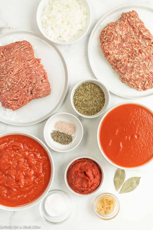 Ingredients needed - ground beef, ground sausage, onion, minced garlic, crushed tomatoes, tomato sauce, tomato paste, bay leaves, italian seasonings, sugar, salt and pepper and beef broth. 