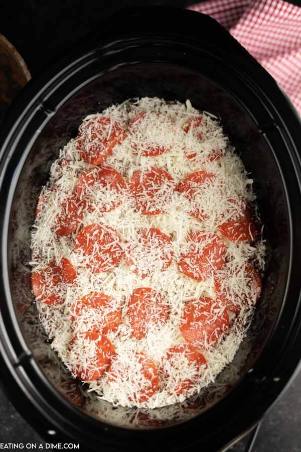 Close up image of mozzarella cheese topped with pepperoni. 