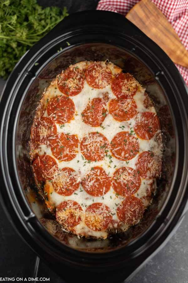 Close up image of pizza casserole in the crock pot. 