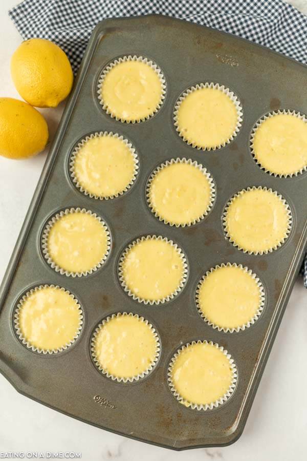 Close up image of lemon cupcake batter in cupcake pan. 