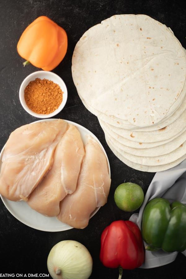 Ingredients for recipe: tortillas, bell peppers, onion, lime, chicken, seasonings. 