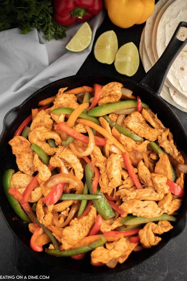 Cast iron skillet of chicken strips, bell peppers and onion. 
