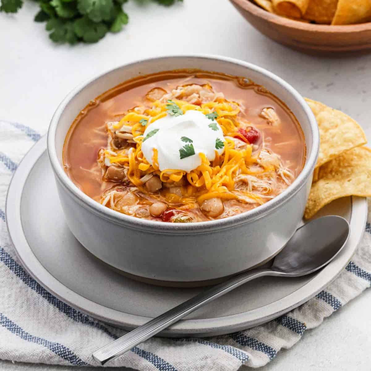 Chicken Taco Soup in a bowl topped with sour cream.