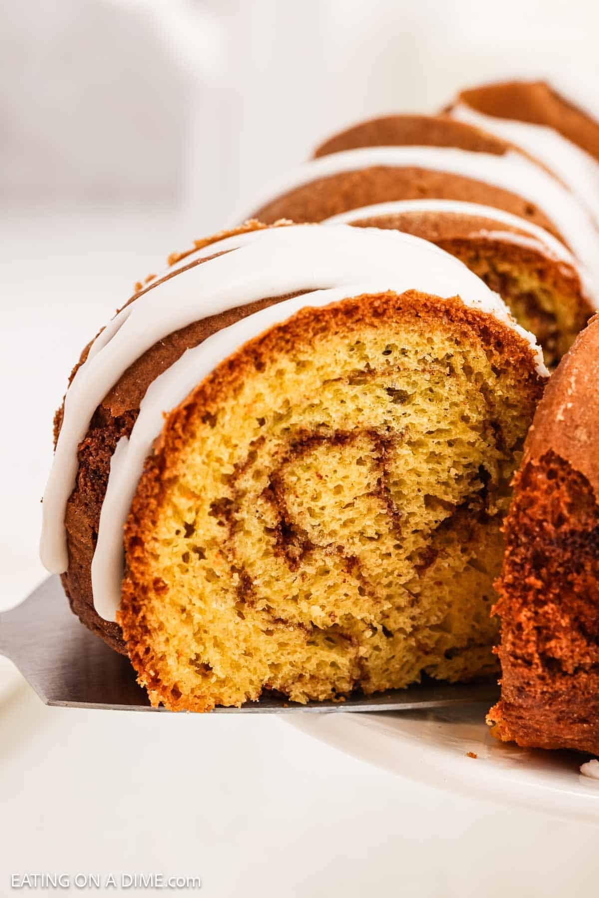 Cinnamon cake sliced and topped with icing.