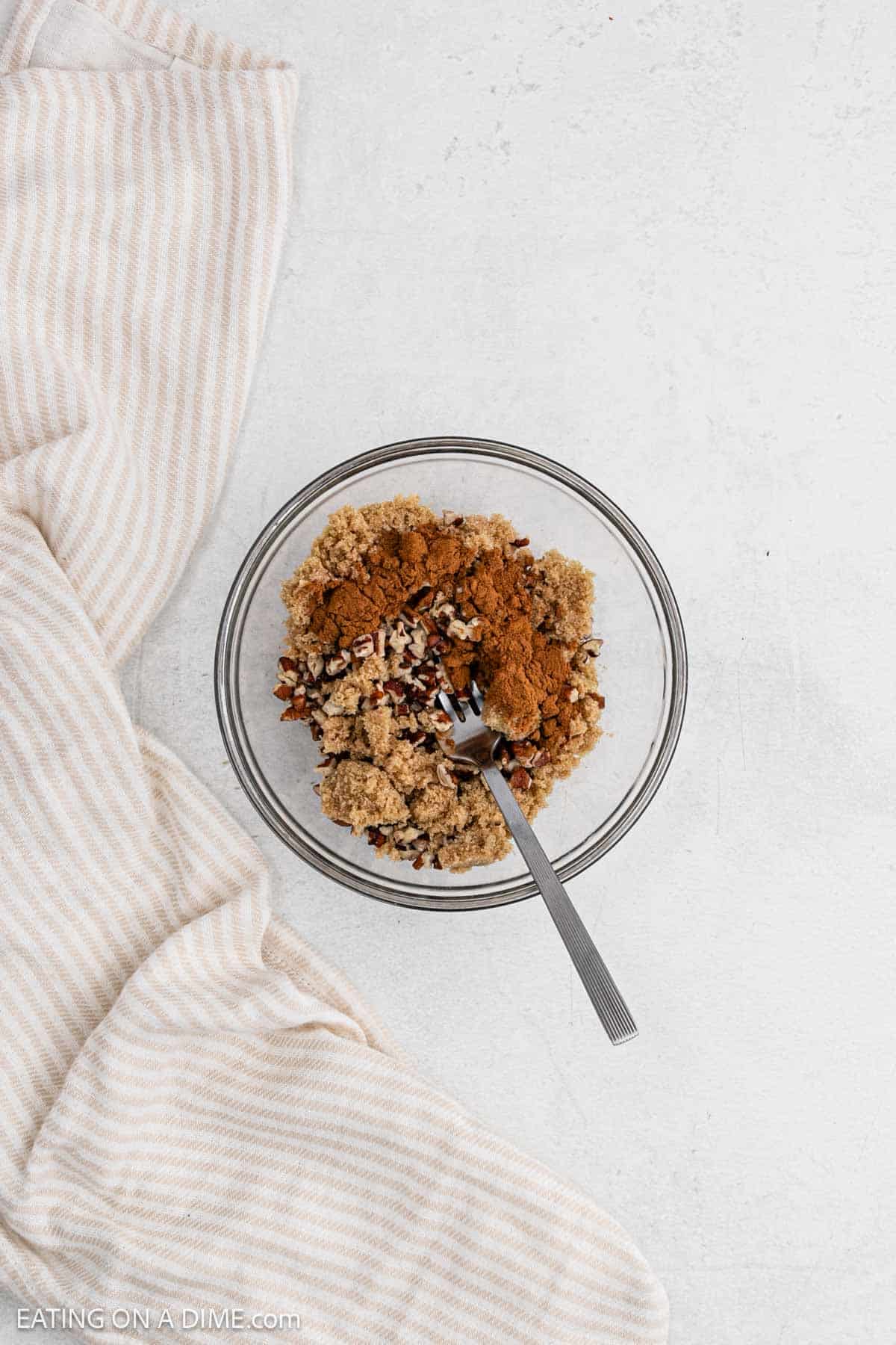 Combining the brown sugar, cinnamon and nuts in a bowl.