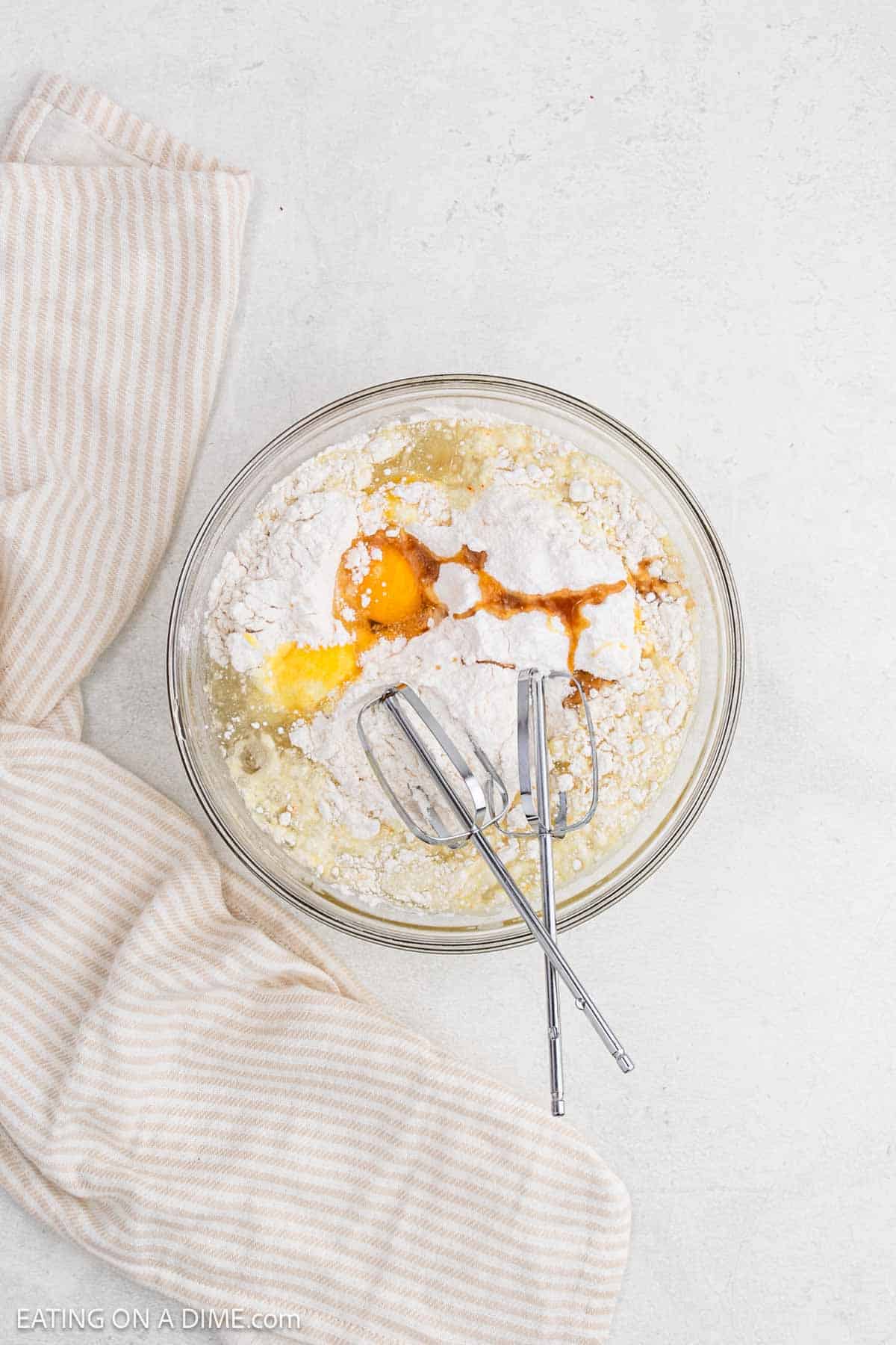 Blending the cake ingredients in a bowl.