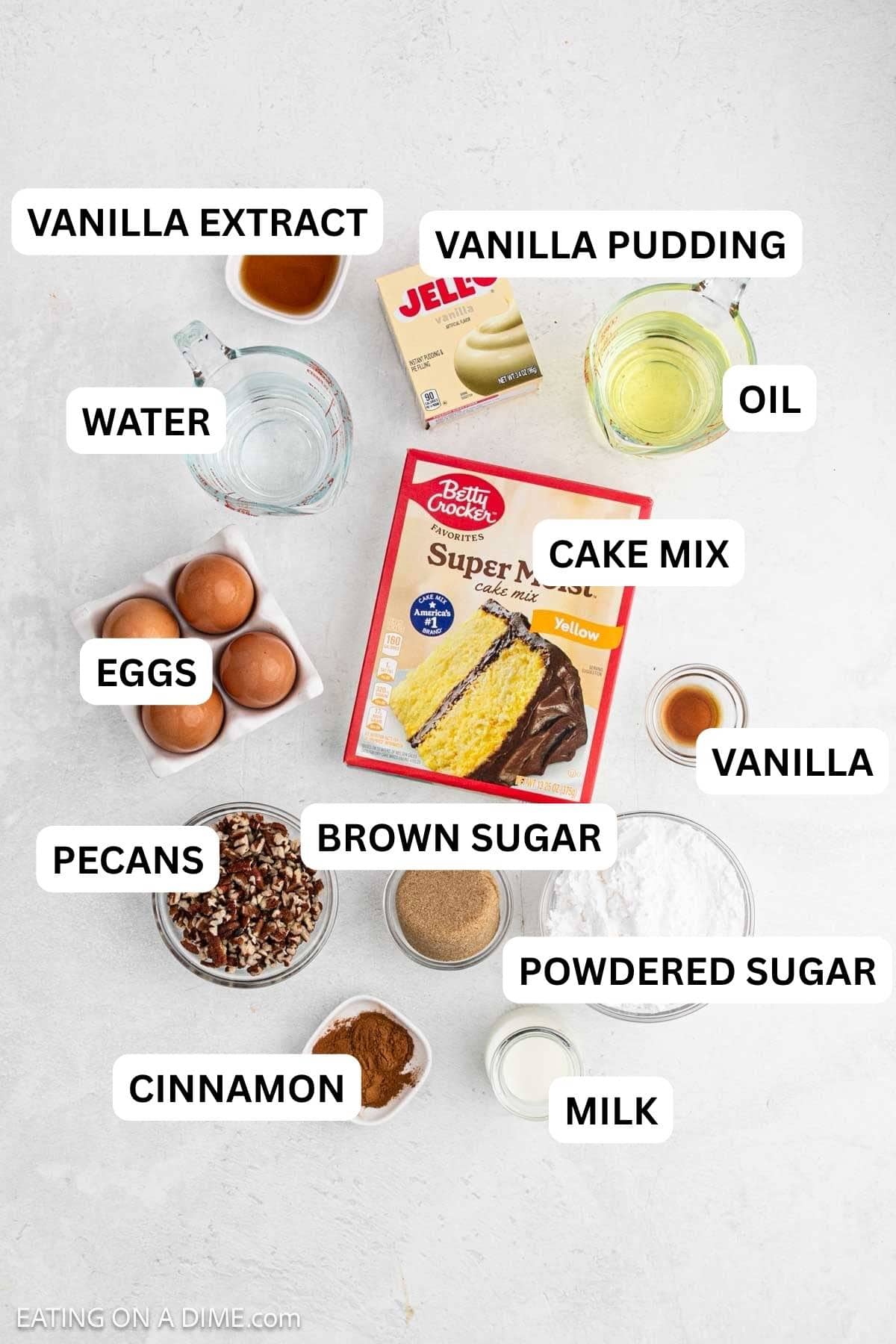 Ingredients needed to make this recipe, cake mix, instant pudding, oil, water, eggs, vanilla extract, brown sugar, cinnamon, powdered sugar, milk and pecans.
