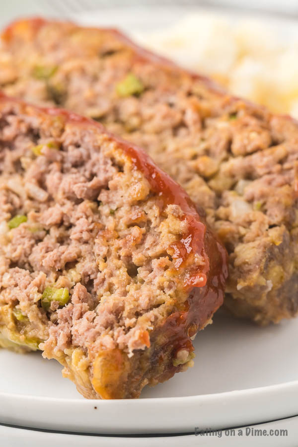 Close up image of meatloaf on a white plate. 