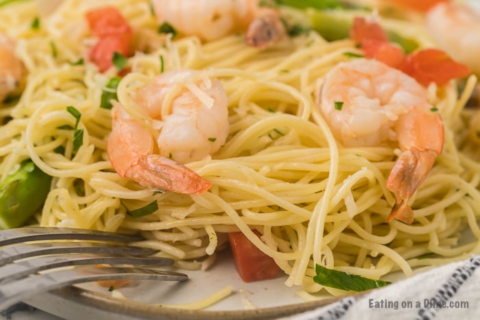 Shrimp scampi on a plate with a fork. 