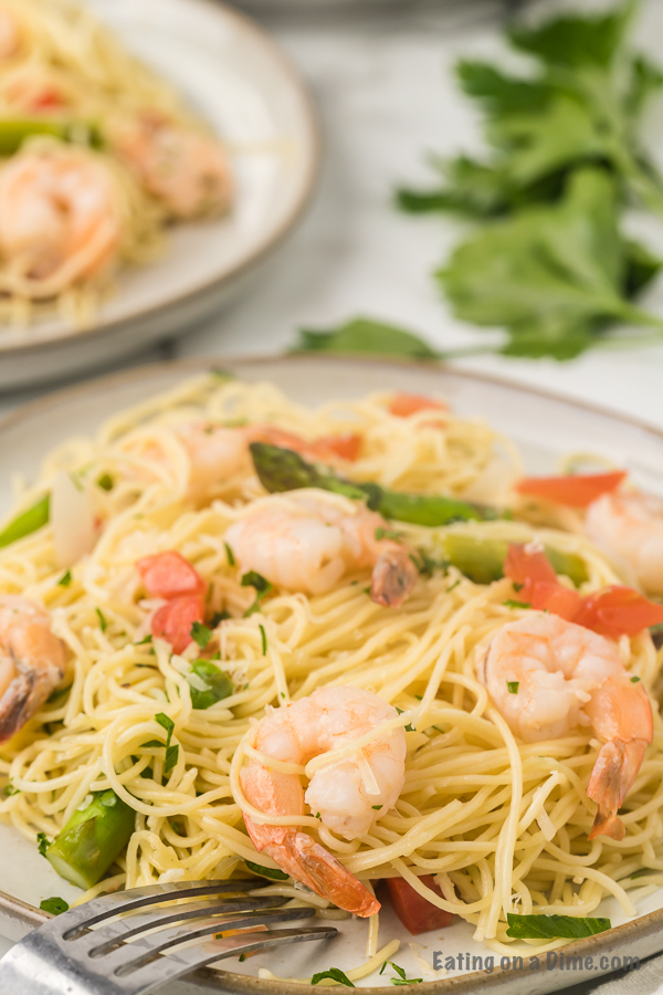 Shrimp scampi on a plate with a fork. 