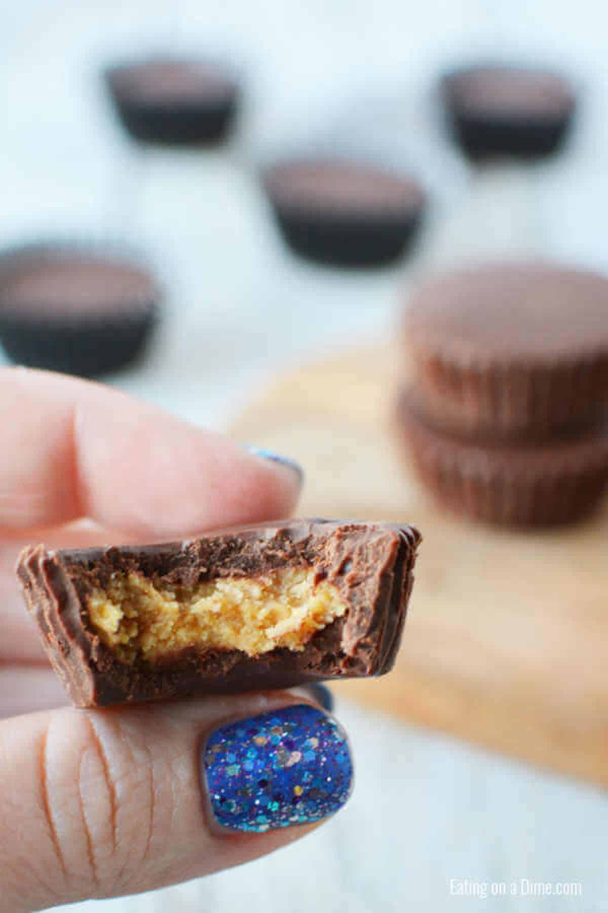 Everyone will love this Chocolate Peanut Butter Cups Recipe. Peanut butter and chocolate fans will go crazy over Easy Chocolate peanut butter cups. Yummy! Peanut Butter bite bit in half.