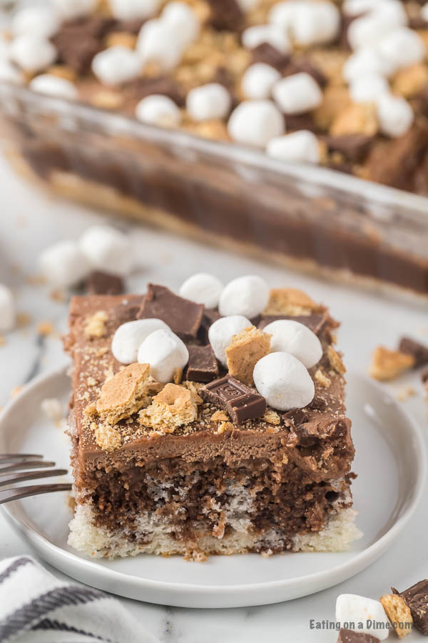 Close up image of smores cake on a white plate. 