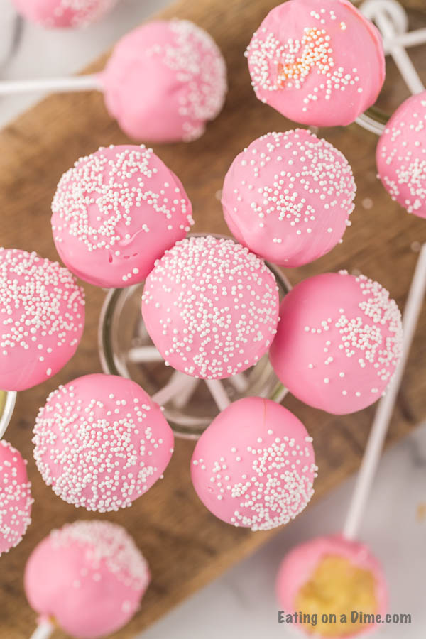 Close up image of pink cake pops in a mason jar. 