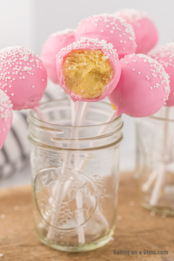 Close up image of pink cake pops in a mason jar. 