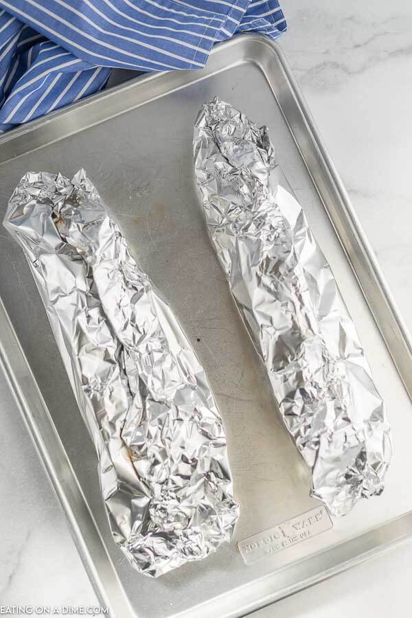 The foil wrapped around the pork on a baking sheet 
