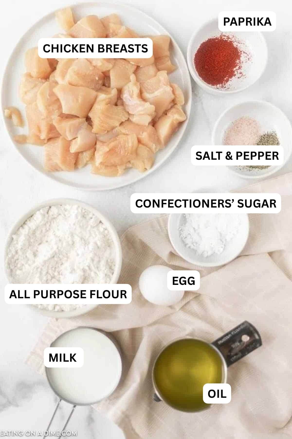 Ingredients for recipe - chicken breasts, salt and pepper, confectioners sugar, flour, egg, oil.