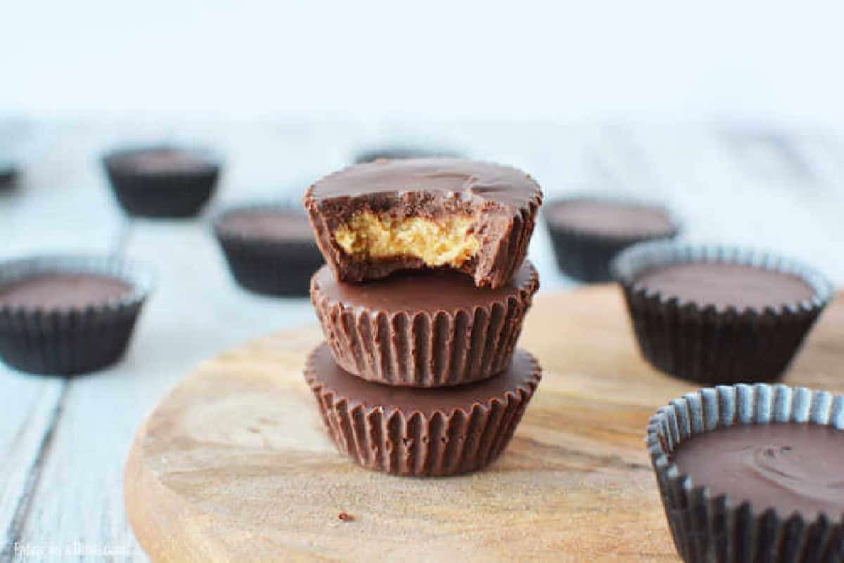 Everyone will love this Chocolate Peanut Butter Cups Recipe. Peanut butter and chocolate fans will go crazy over Easy Chocolate peanut butter cups. Yummy! Close up image of peanut butter cups on a table.