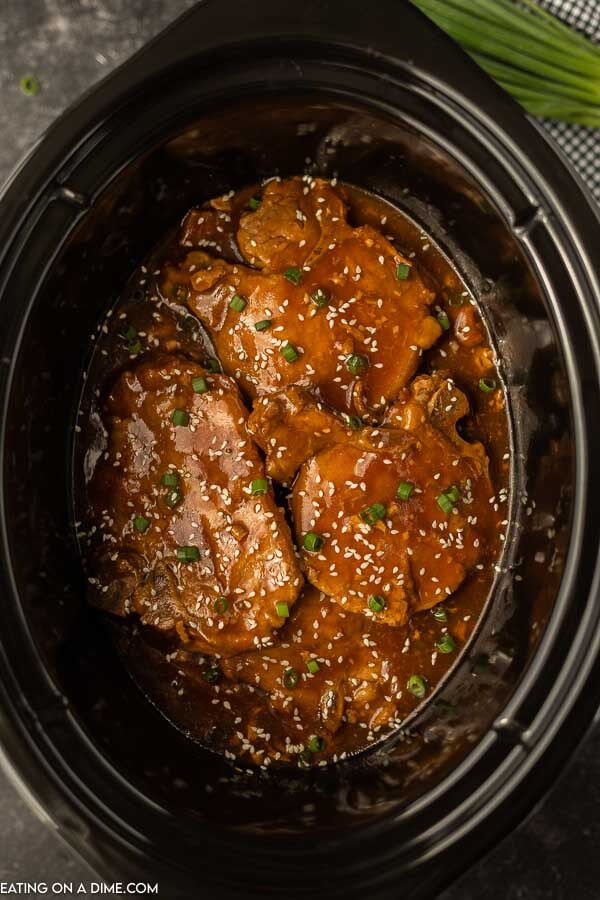 Close up image of teriyaki pork chops in the crock pot. 