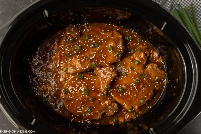 Close up image of teriyaki pork chops in crock pot. 