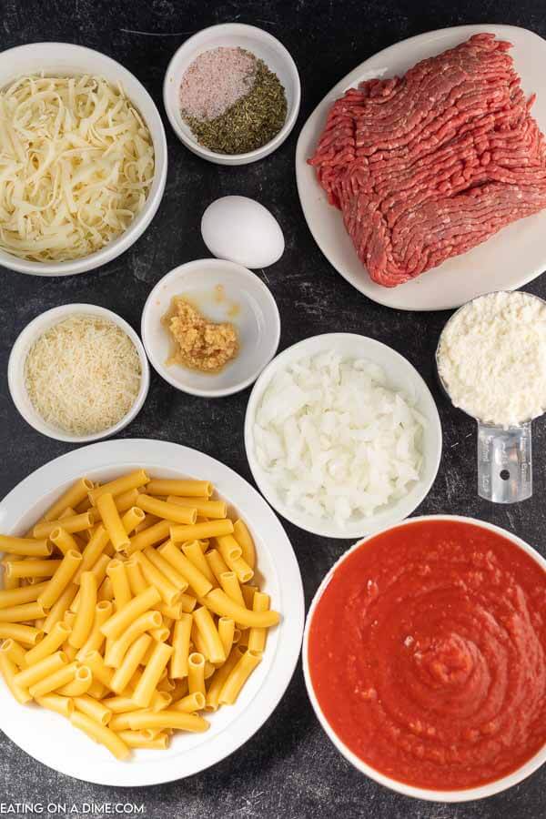 Ingredients for recipe: ground beef, ground sausage, onion, minced garlic, salt, Italian seasoning, diced tomatoes, crushed tomatoes, beef broth, penne, ricotta cheese, mozzarella cheese. 