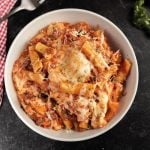 Italian pasta bake in a white bowl.