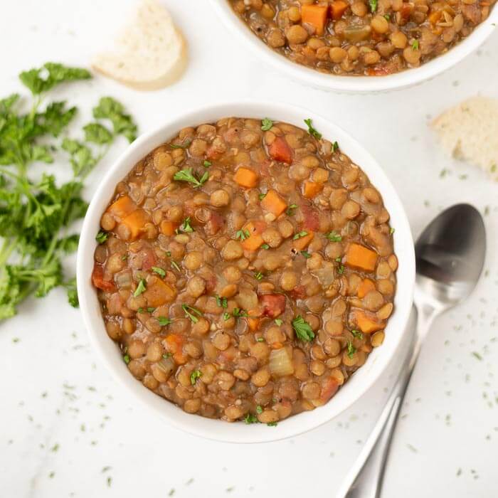 Close up image of lentil soup in a white bowl