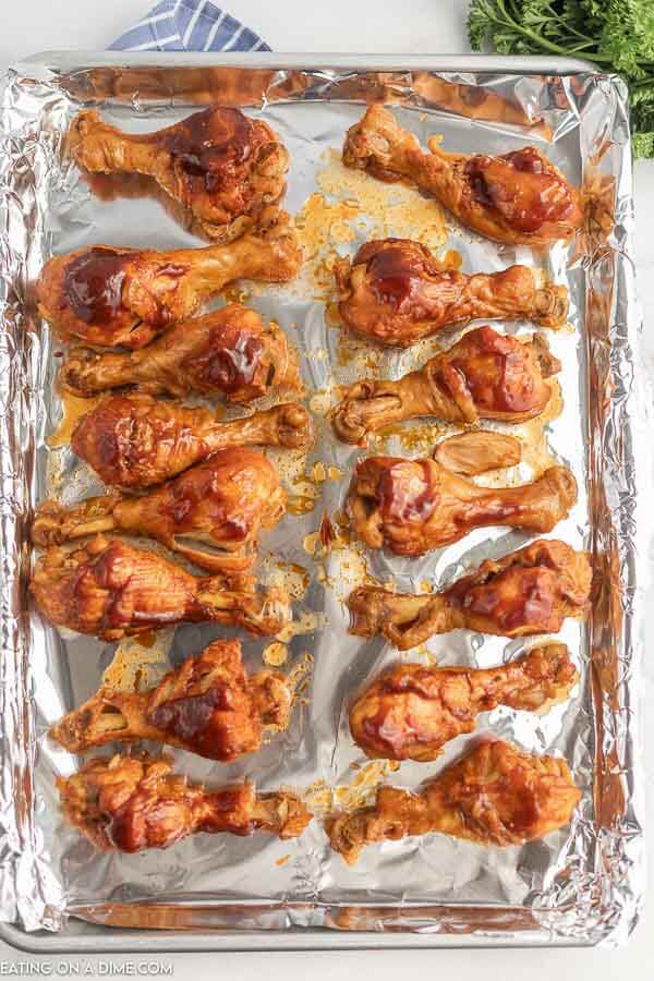 The cooked chicken drumsticks placed on a foil ready to broil 