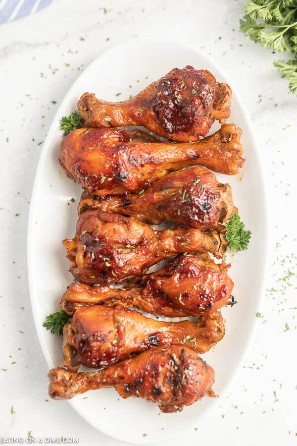 Cooked Chicken Drumsticks on a white platter 