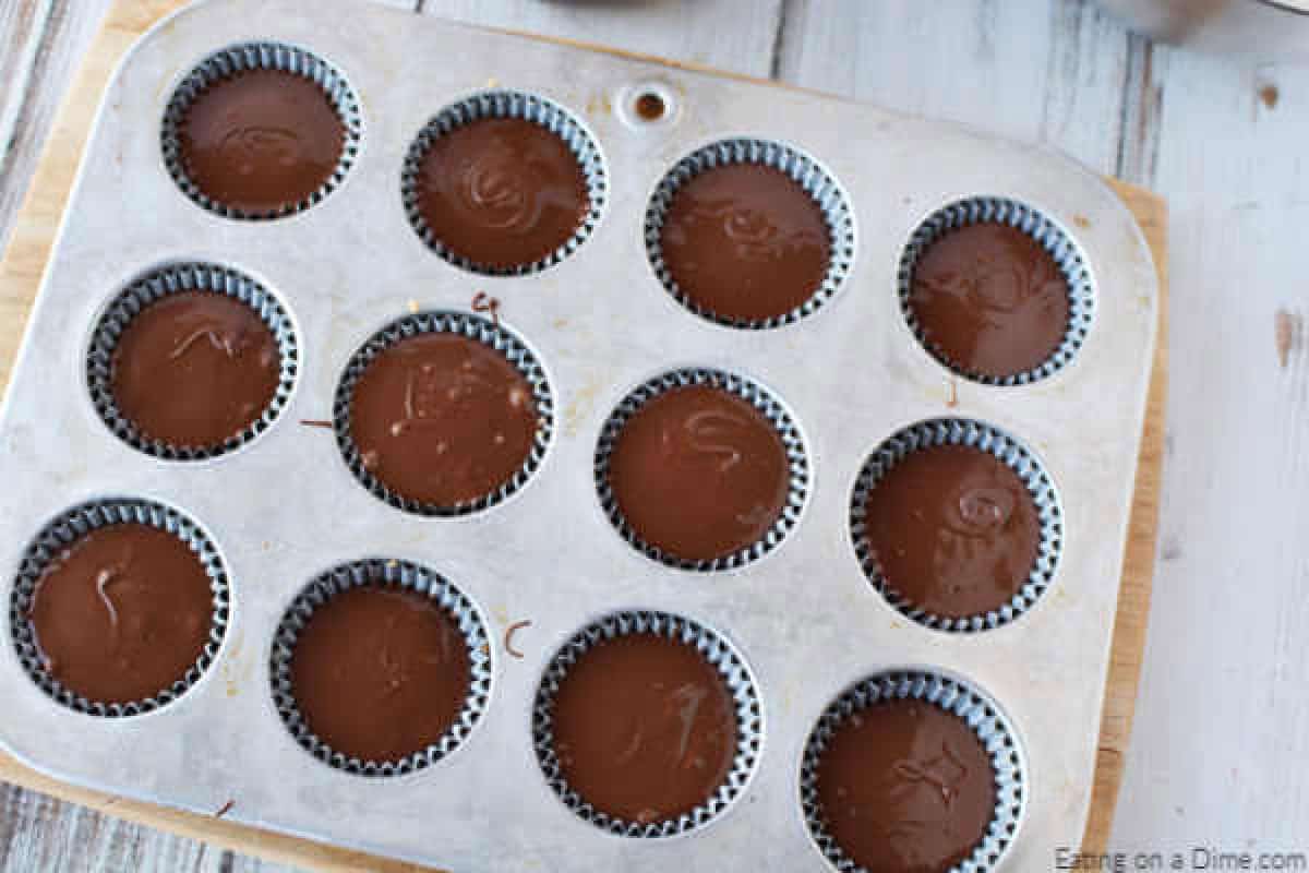 Homemade chocolate peanut butter cups in a muffin pan.