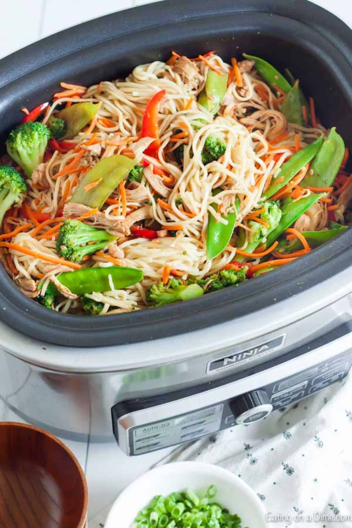 Our family loves Chinese take out but now we can make Crock Pot Chicken Chow Mein Recipe at home and save time and money. This recipe tastes amazing. Close up image of Chicken Chow Mein in the crock pot.
