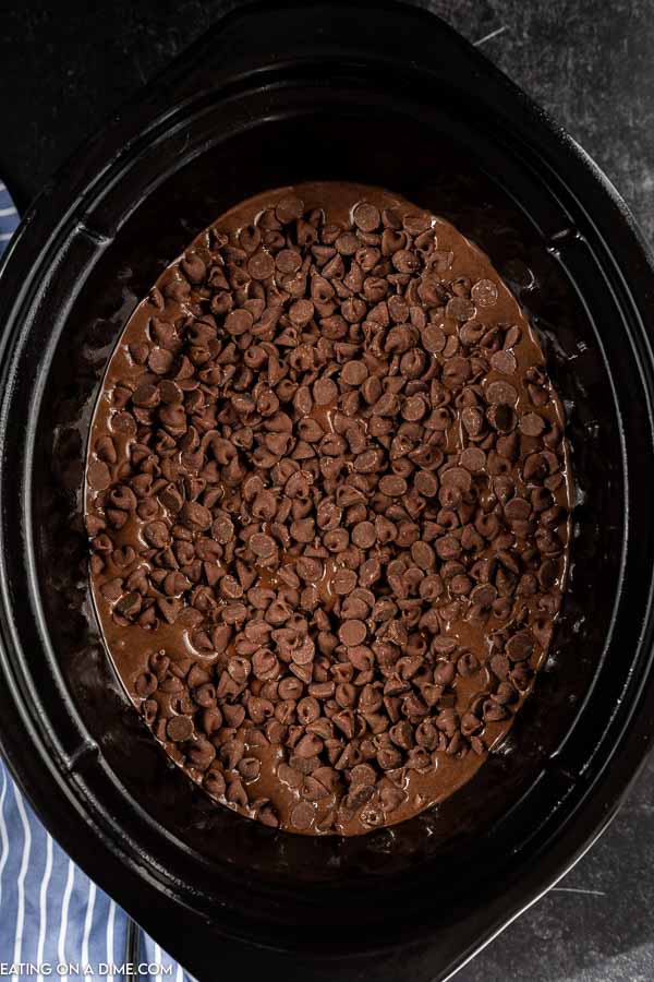 Close up image of chocolate lava cake uncooked in the crock pot. 