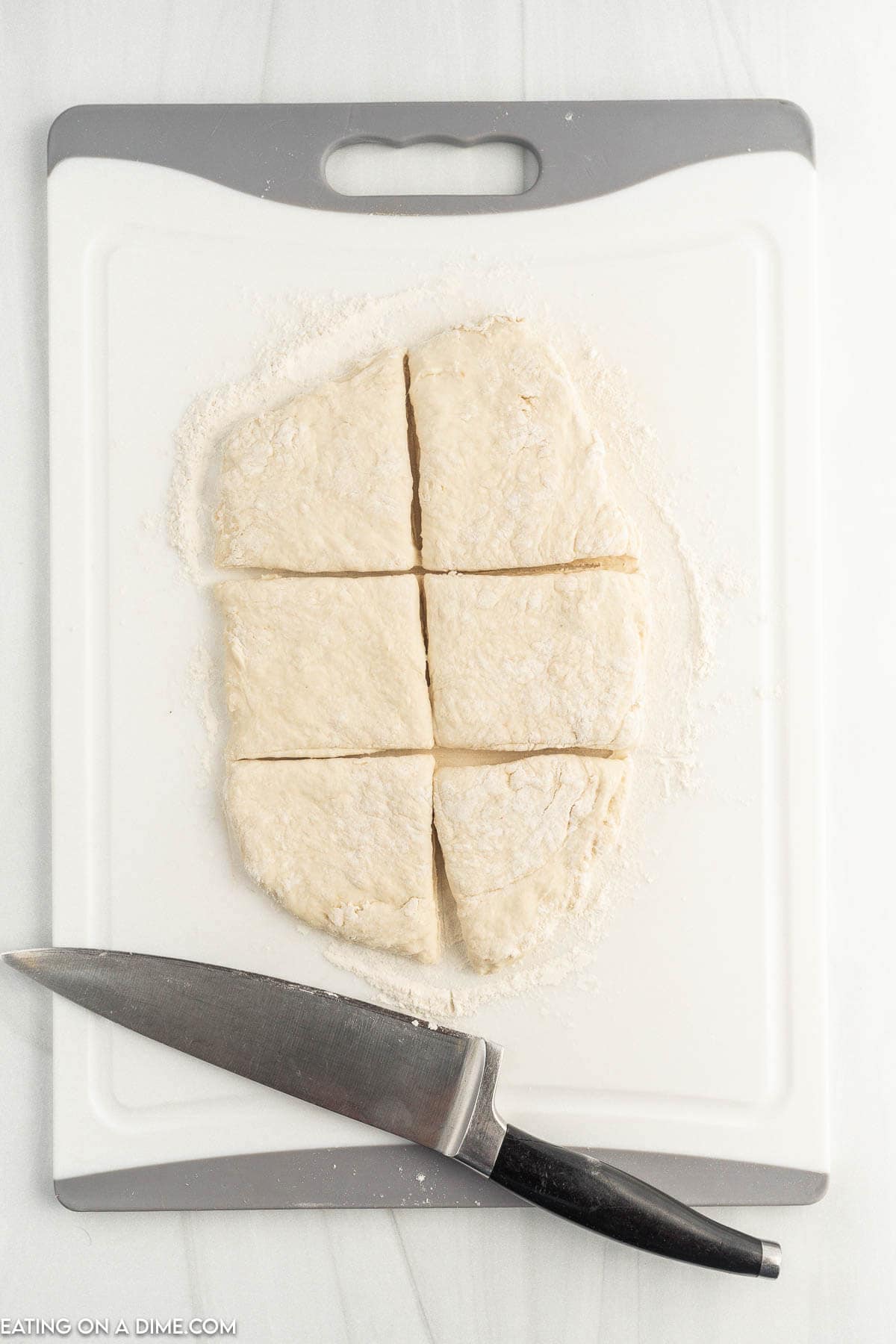 Cutting dough into 6 pieces on a cutting board