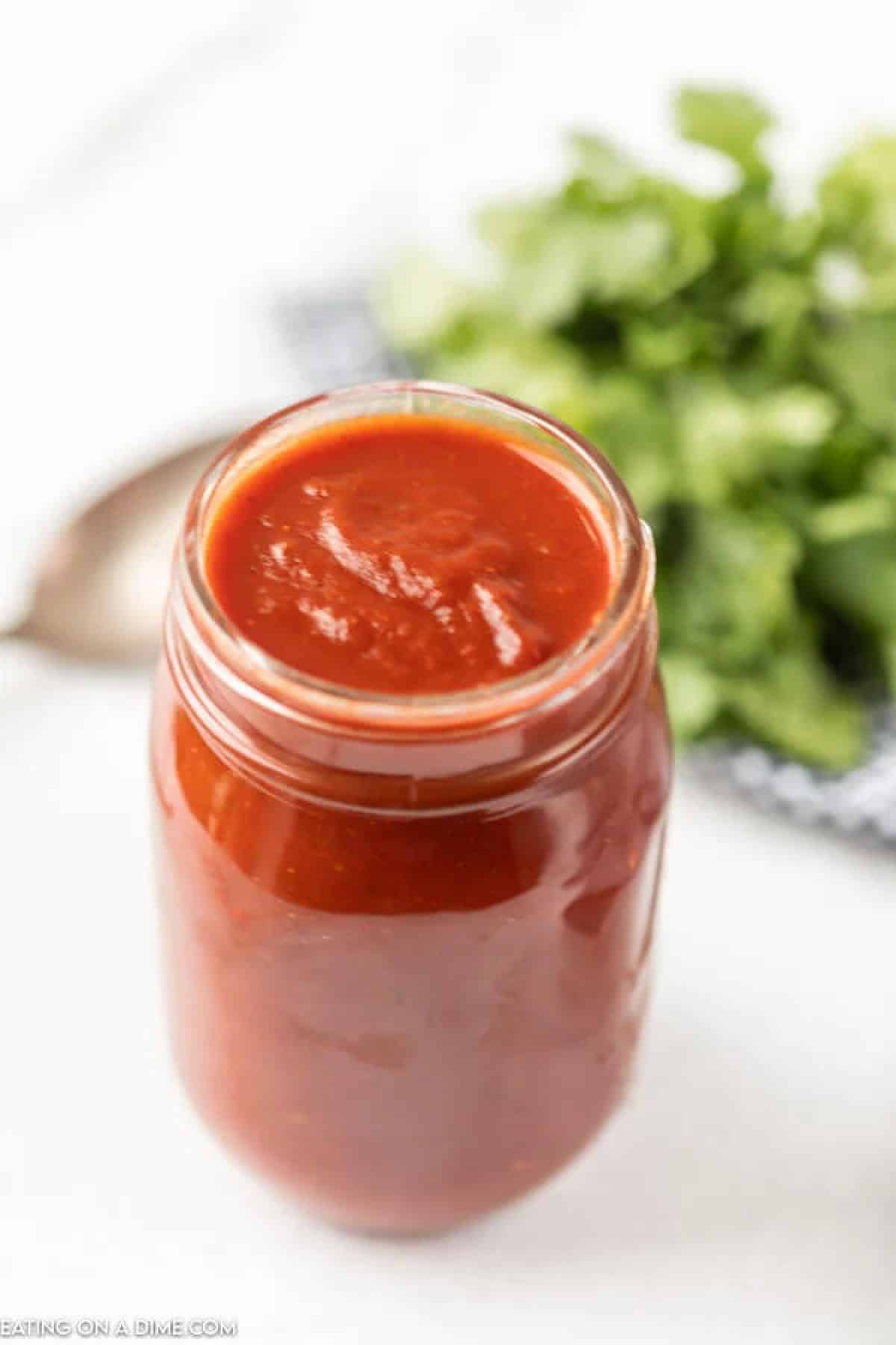 Close up image of Red Enchilada Sauce in a Mason Jar.