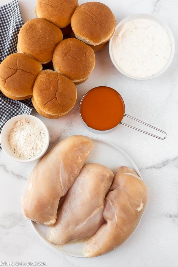 Ingredients for recipe: buns, buffalo sauce, ranch mix and dressing, chicken breasts.