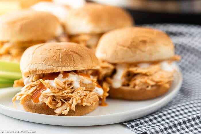 Shredded buffalo chicken sandwich on a plate. 