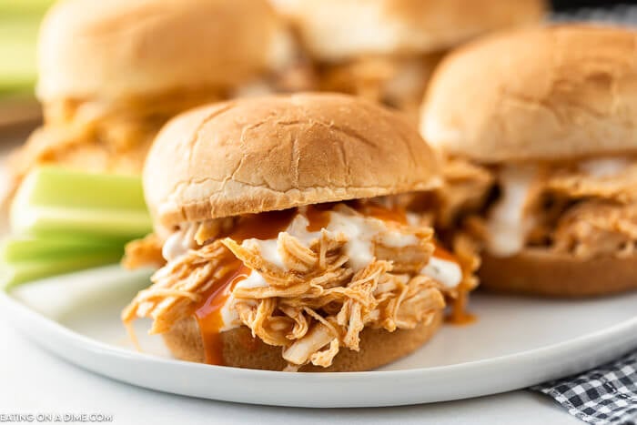 Shredded buffalo chicken sandwich on a plate. 