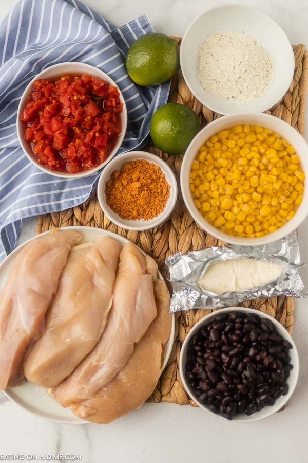 Ingredients needed for fiesta lime chicken - chicken breast, ranch seasoning mix, taco seasoning, black beans, rotel, corn, cream cheese, fresh limes and chicken broth. 