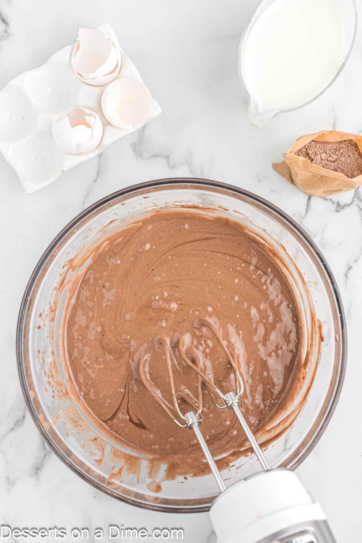 Combining the cake mix, oil, eggs, and milk in a bowl with a hand mixer