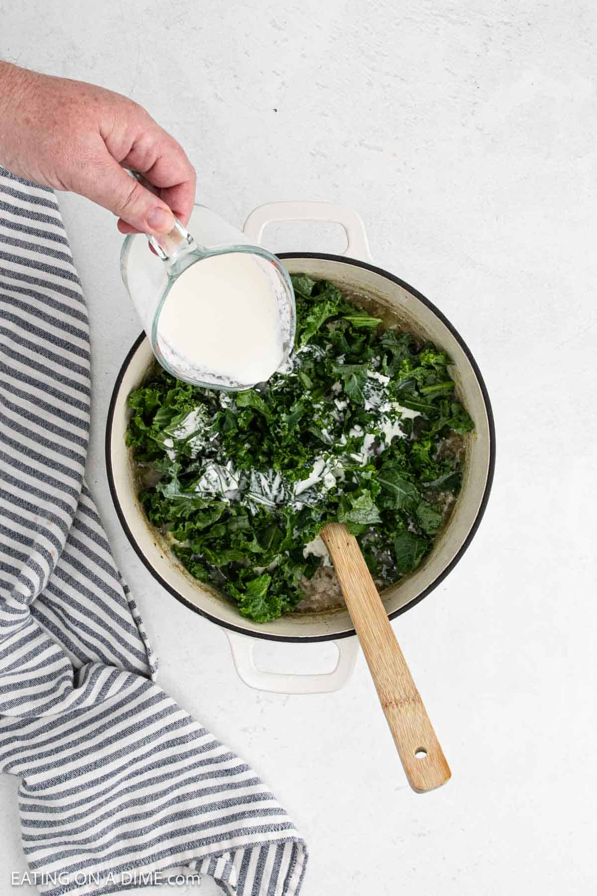 Chopped kale and cream added to the large pot of soup.