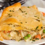 Close-up of a piece of pot pie casserole on a white serving plate.