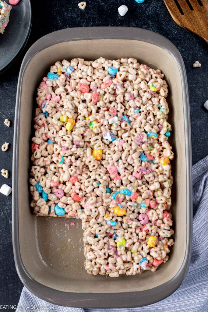 The lucky Charm Treats in a baking pan with one of the treats removed from the pan. 