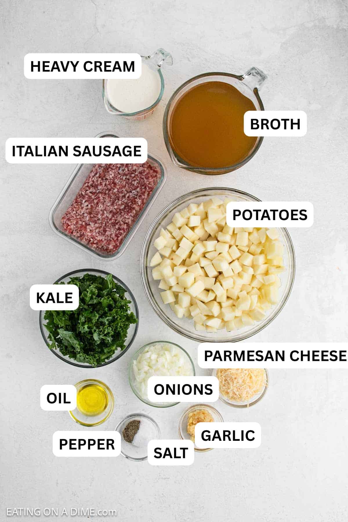 Ingredients needed for this recipe including Italian Sausage, oil, garlic, onion, potatoes, broth, kale, heavy whipping cream, and parmesan cheese.