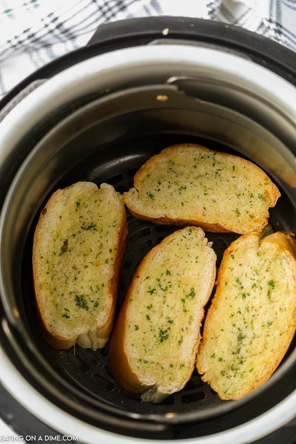 Garlic bread in the air fryer basket. 