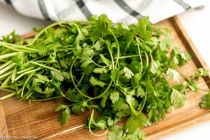 Close up image of cilantro on a cutting board. 