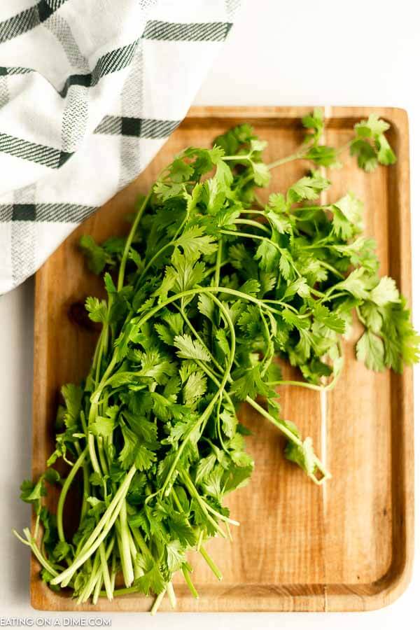 Close up image of cilantro on a cutting board. 