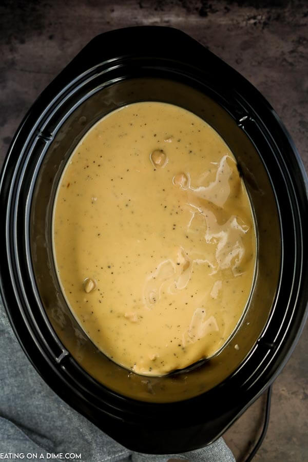 Close up image of pork chops and gravy in a crock pot. 