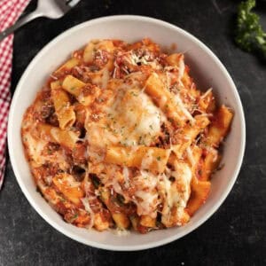 Italian pasta bake in a white bowl.