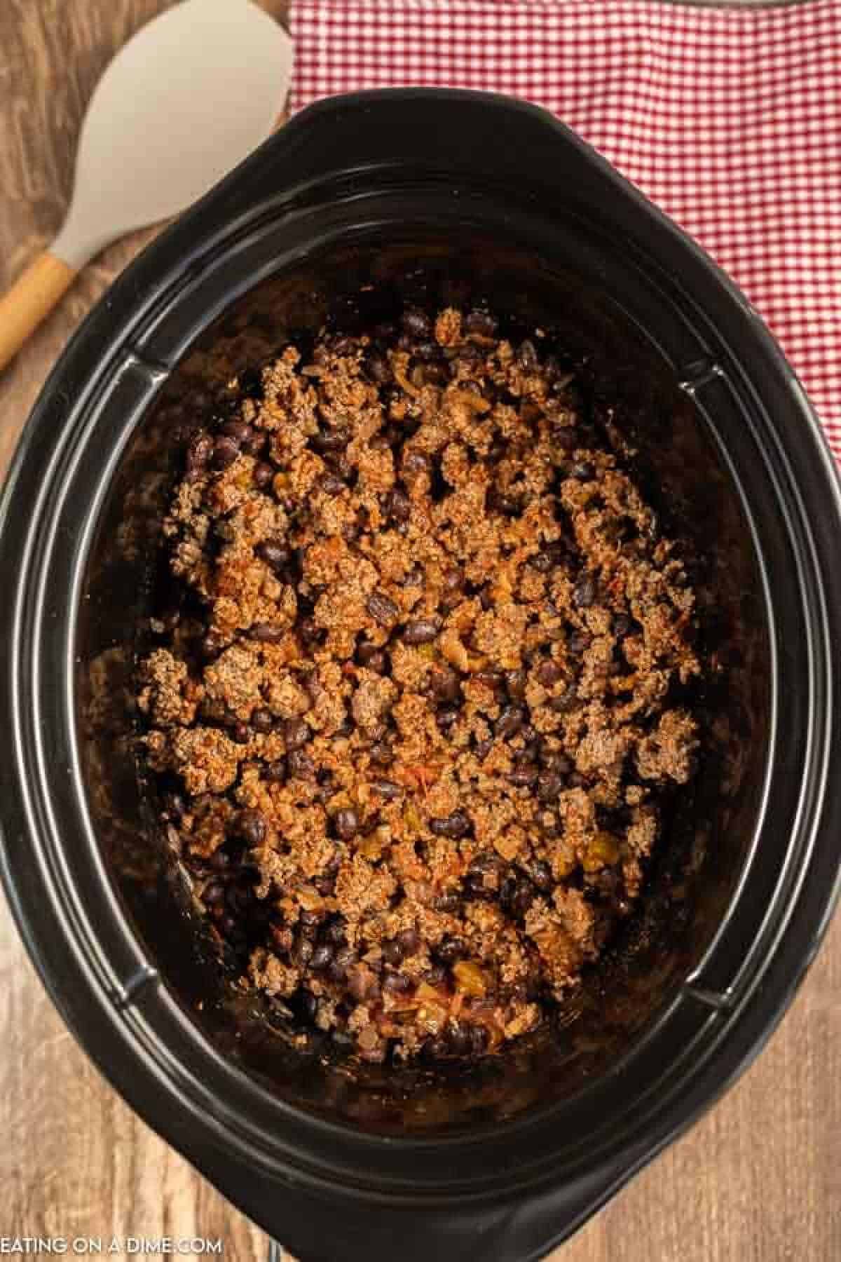 Close up image of taco meat in a crock pot.